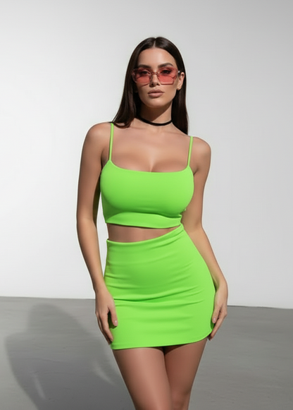 Woman wearing a bright green top and electric green skirt 