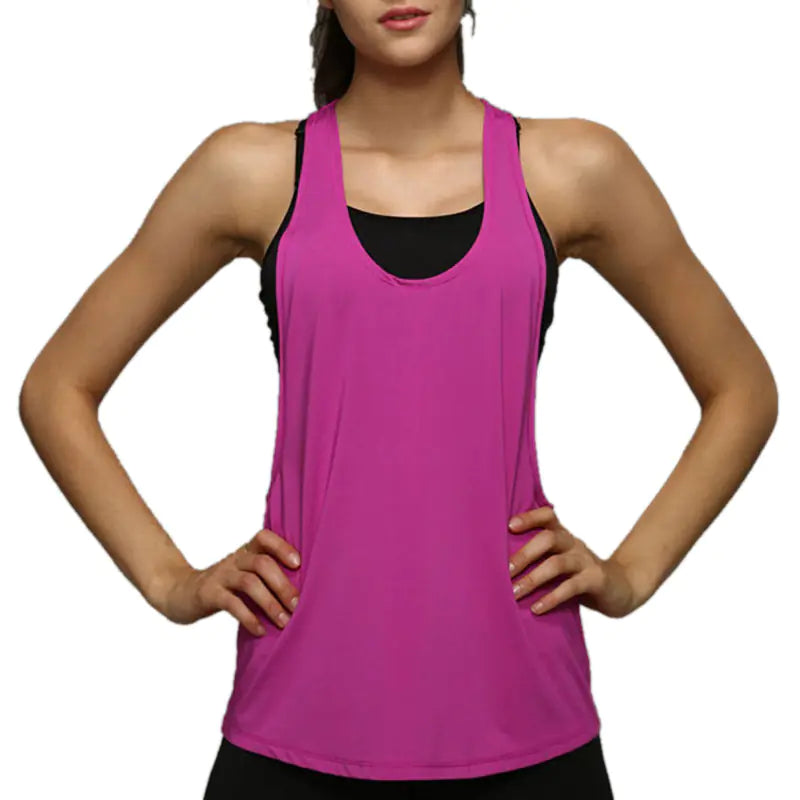 Woman wearing a pink tank top with black trim on a white background