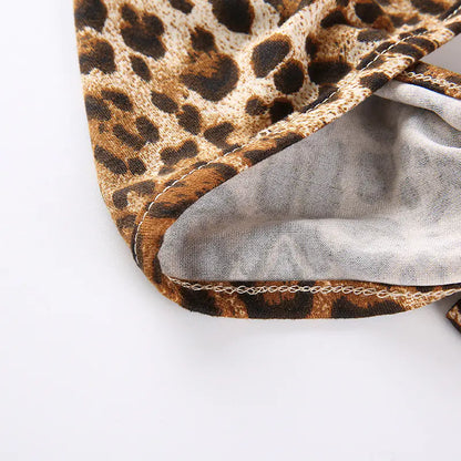 Close-up of a leopard print fabric edge with a gray fabric background