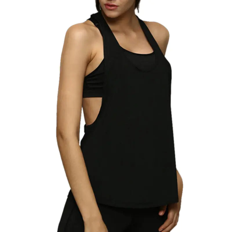 Black sleeveless top worn by a person on a white background