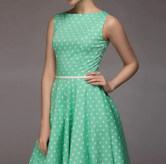 Green polka dot dress on a gray background