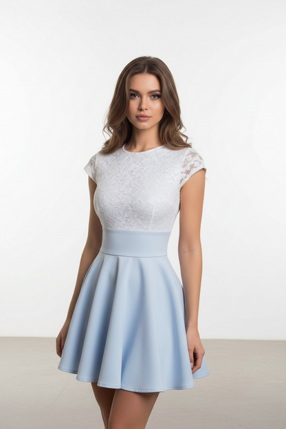 Woman wearing a white lace top and light blue skirt against a white background