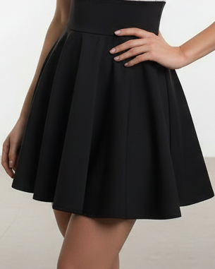 Black skirt worn by a person on a plain background