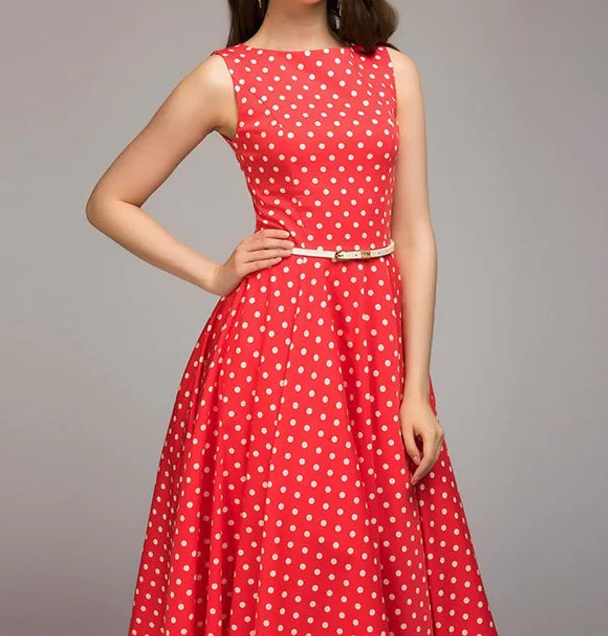 Red polka dot dress with a belt on a gray background