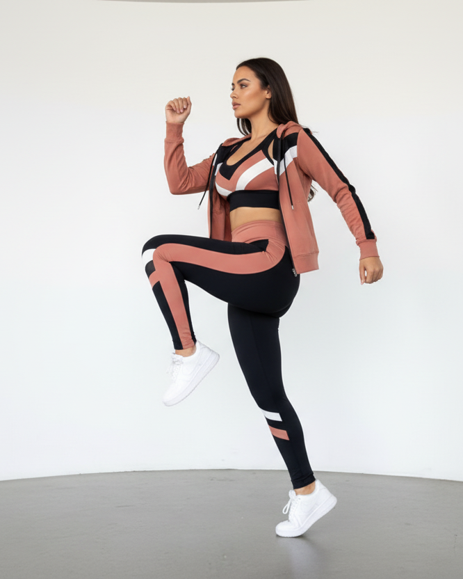 Woman in athletic wear posing against a white background