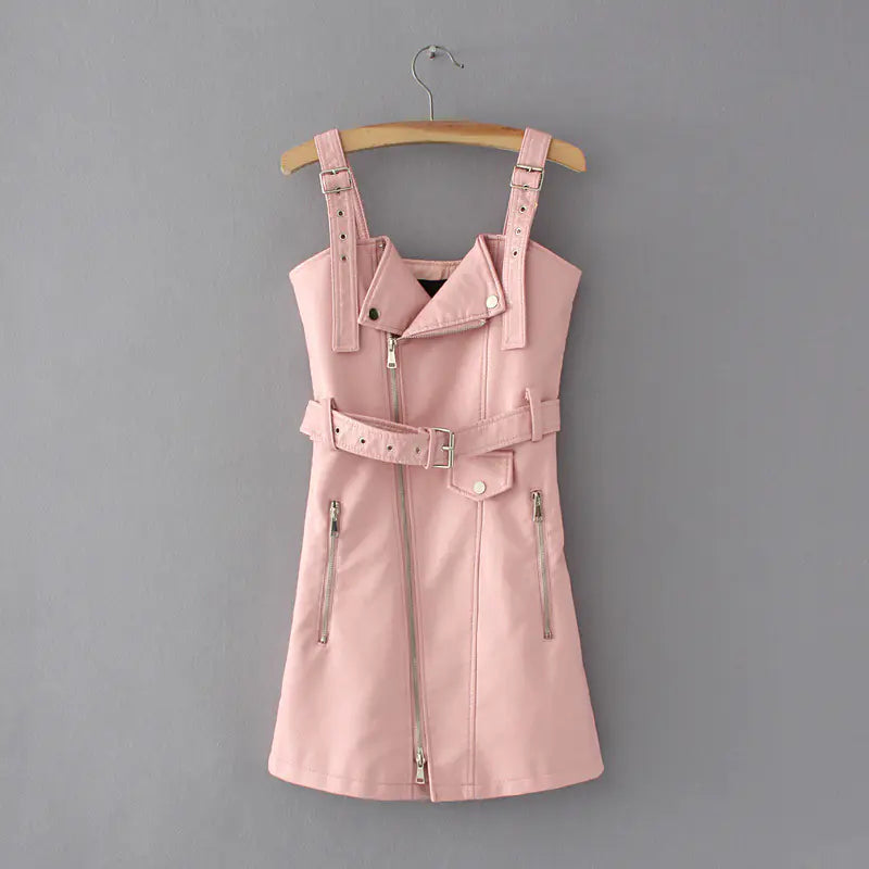 Pink leather dress with straps on a hanger against a gray background