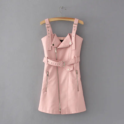 Pink leather dress with straps on a hanger against a gray background