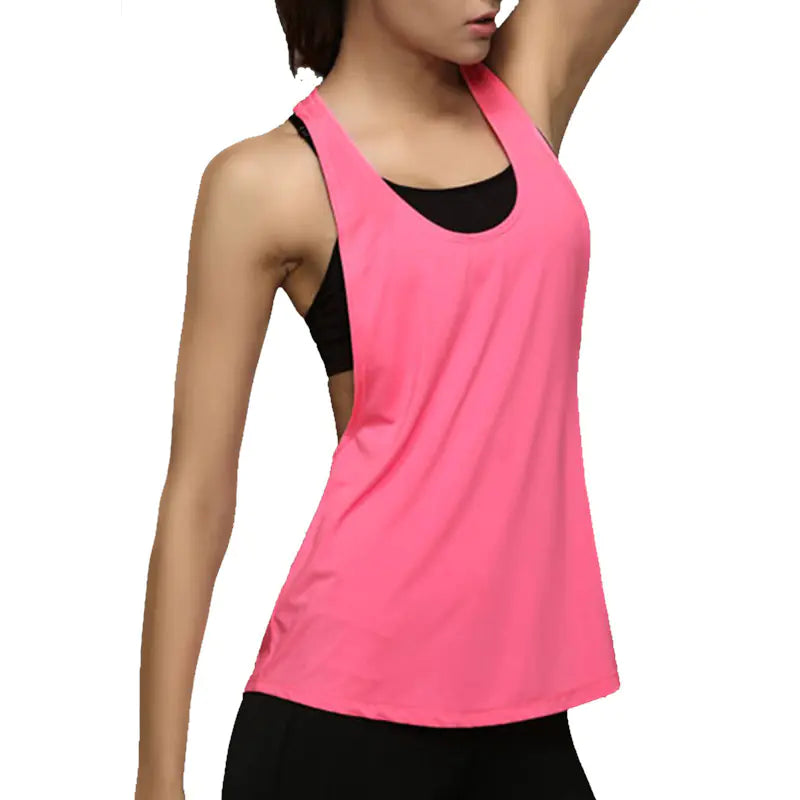 Pink tank top with black accents worn by a model on a white background
