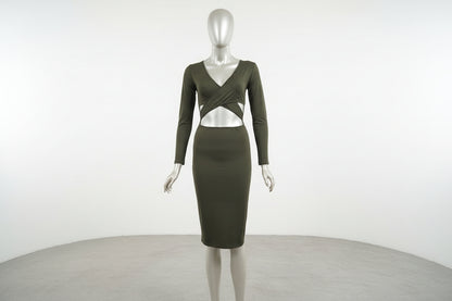 Mannequin wearing a green dress with cut-out design on a white background