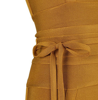 Close-up of a mustard yellow dress with a tie waist on a white background