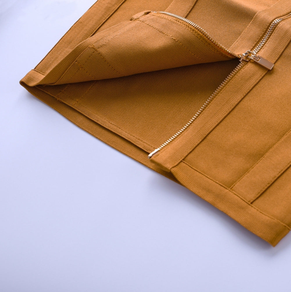 Close-up of a mustard yellow dress with a zipper on a light blue background