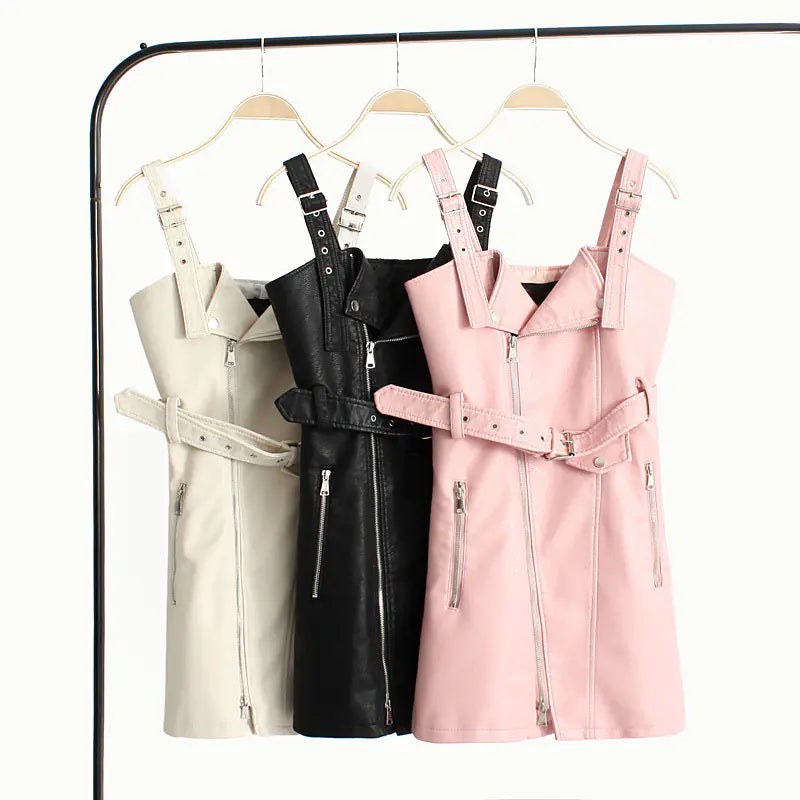 Three dresses in beige, black, and pink hanging on a rack.