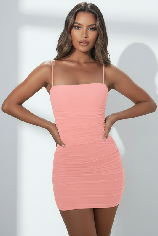 Woman wearing a pink dress against a white background