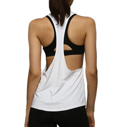 Person wearing a white tank top with cut-out design and black sports bra underneath on a white background